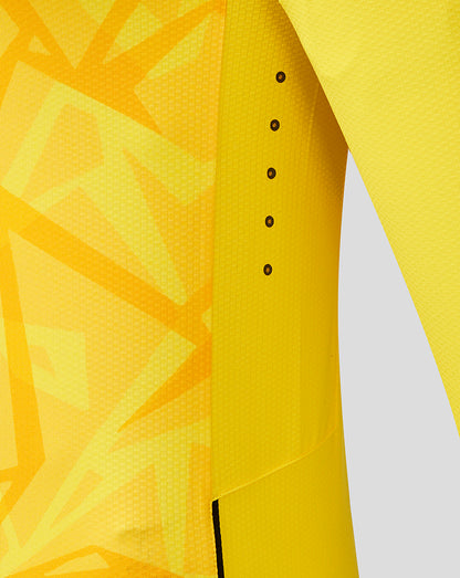Close-up of yellow Wolves Pro Third Goalkeeper long sleeve shirt showing geometric pattern and vertical row of black vent eyelets along the side