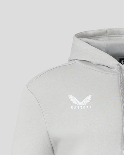 Close up of light grey hoodie showing hood edge and forward shoulder seam with heat sealed Castore logo on the chest