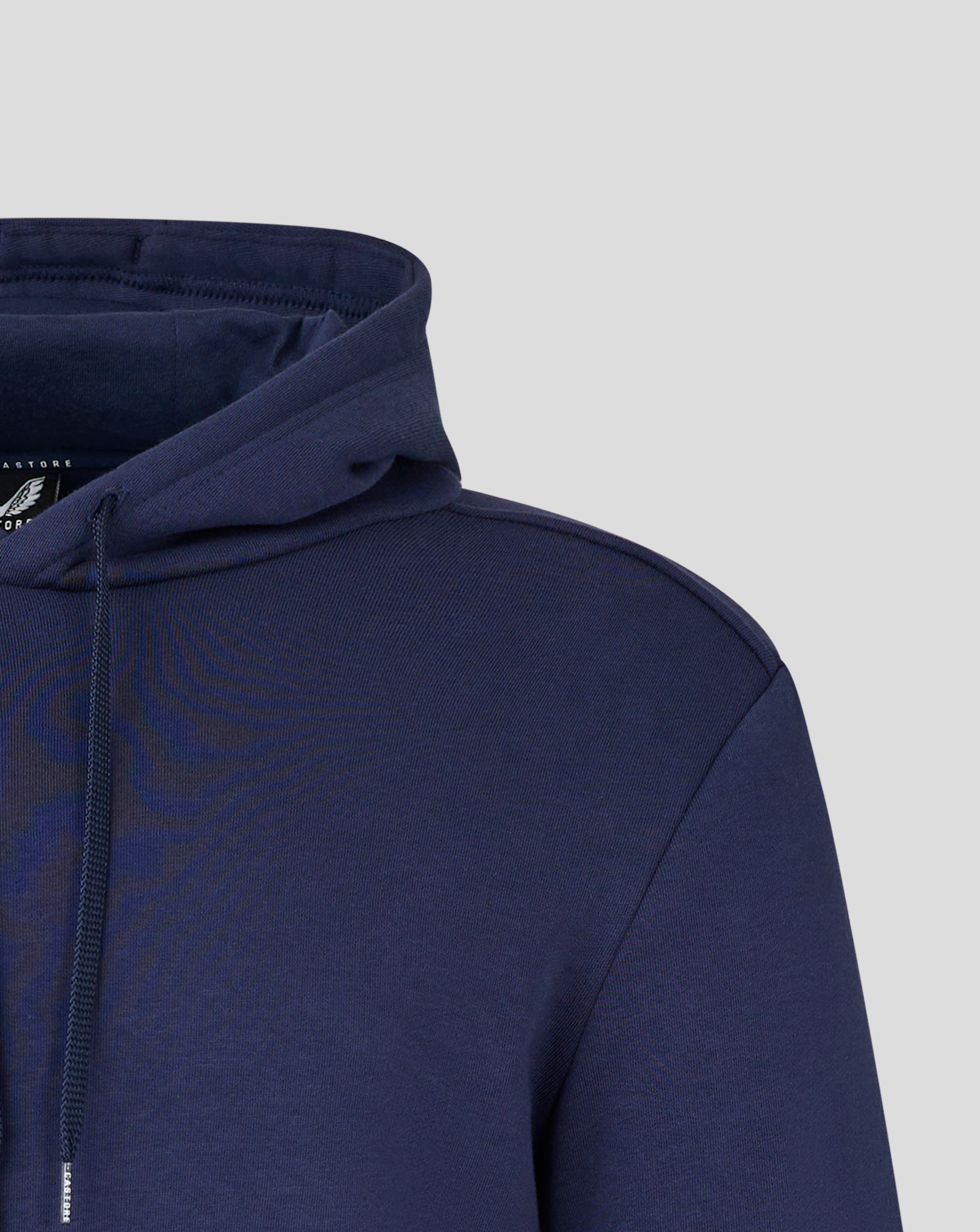 Close up of navy hoodie hood edge and shoulder seam against light gray background