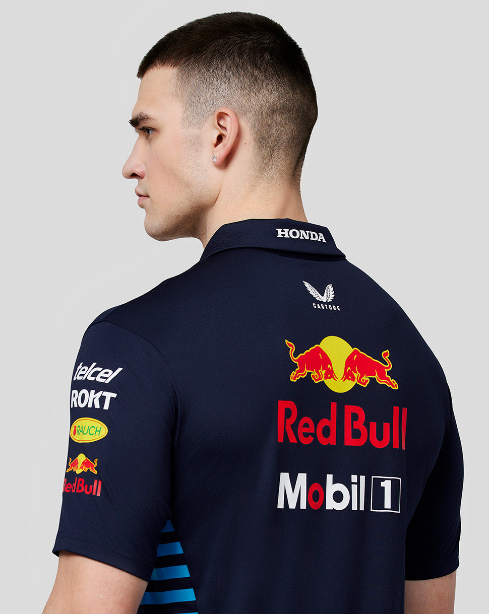 Back view of a male model wearing a navy Oracle Red Bull Racing polo with large Red Bull and Mobil 1 logos.