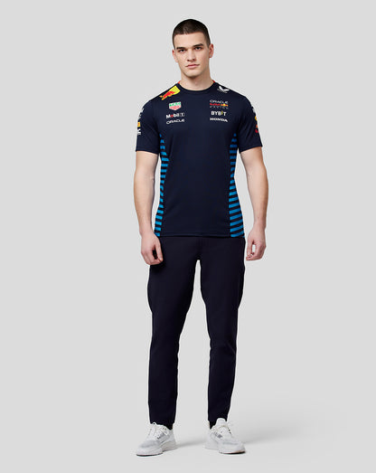 Full body shot of male model in navy Oracle Red Bull Racing Teamline Set Up T Shirt Night Sky paired with navy pants and white sneakers