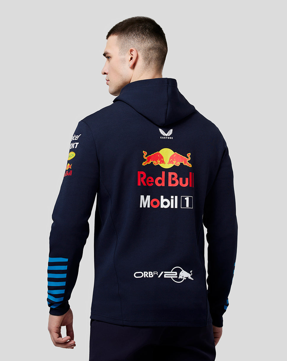 Back view of navy teamline hoodie on model with large Red Bull graphic on back and blue striped cuffs