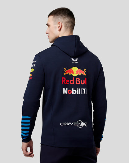 Back view of navy teamline hoodie on model with large Red Bull graphic on back and blue striped cuffs
