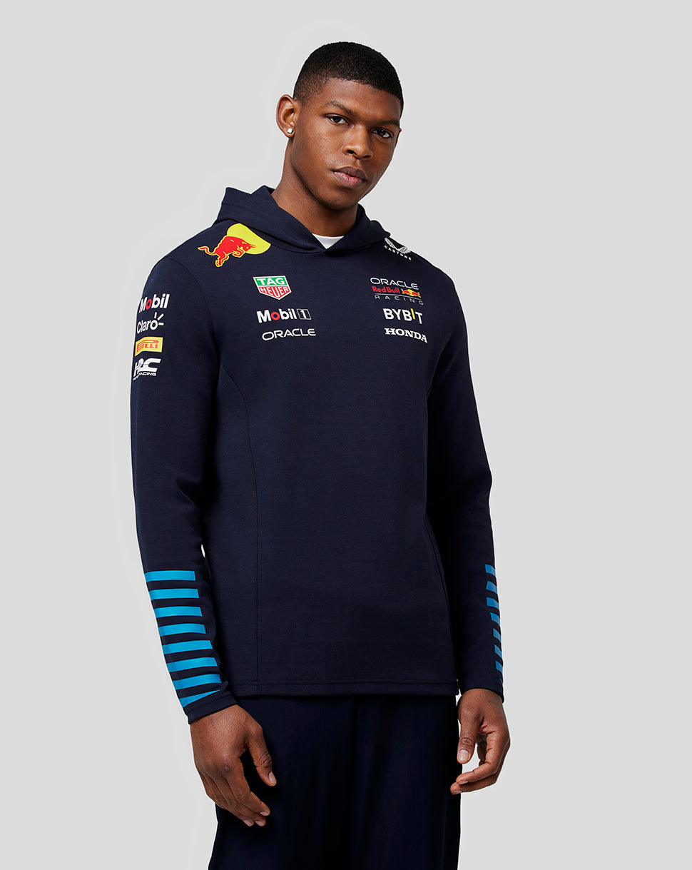 Man in navy Teamline pullover hoodie with multiple sponsor logos on chest and blue striped sleeves