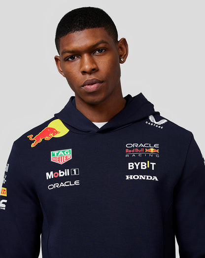 Close-up of a model in a navy Teamline hoodie showing chest sponsor logos and branding