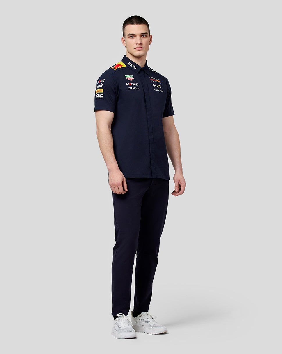 Front view of model wearing navy Oracle Red Bull Racing Teamline shirt with chest and sleeve sponsor logos