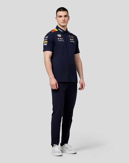 Front view of model wearing navy Oracle Red Bull Racing Teamline shirt with chest and sleeve sponsor logos
