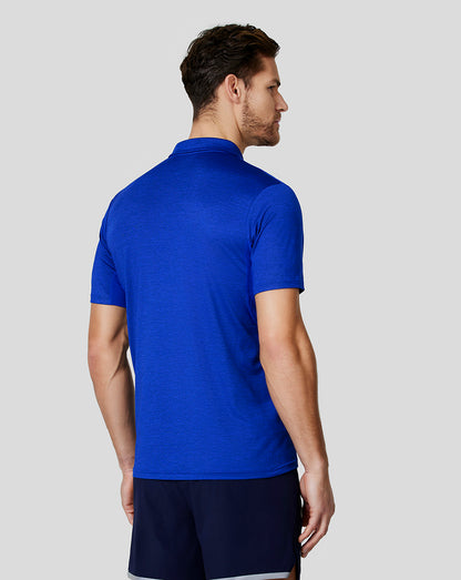 Back view of a male model wearing a bright blue Oracle Red Bull Racing polo shirt