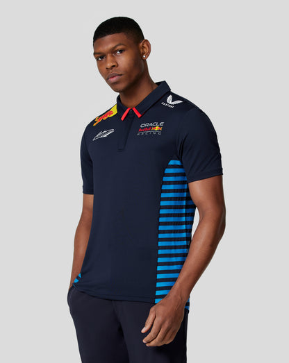 Front view of a man wearing a navy Oracle Red Bull Racing polo with team logos and blue side stripes