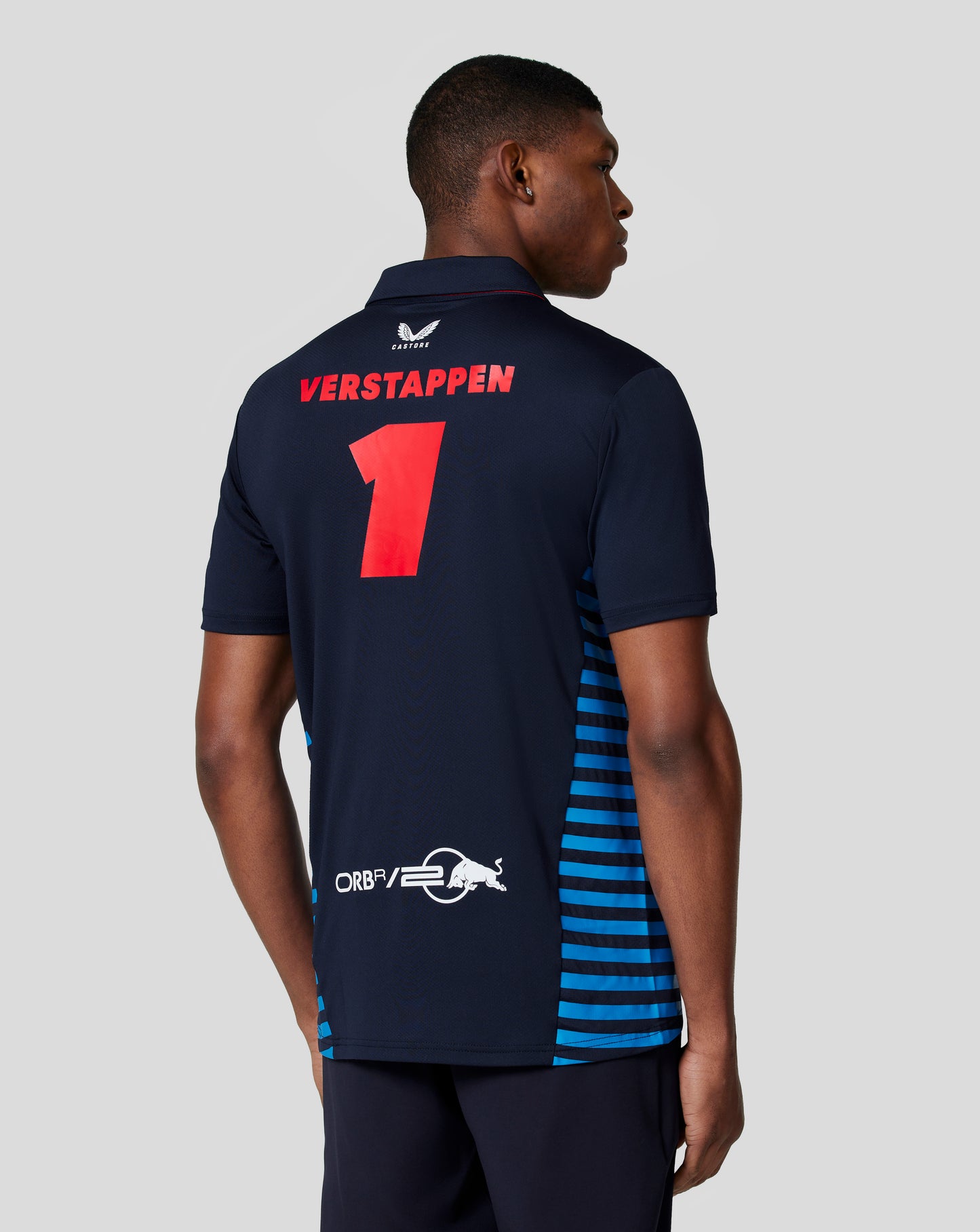 Back view of a navy Verstappen polo displaying the name Verstappen and large red number on the back