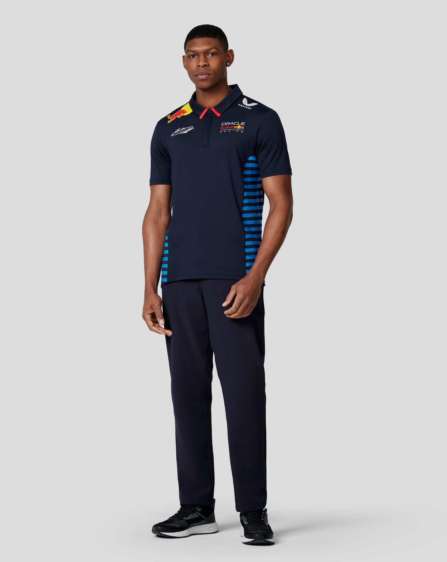 Back view of a navy polo with bold Verstappen lettering on the upper back