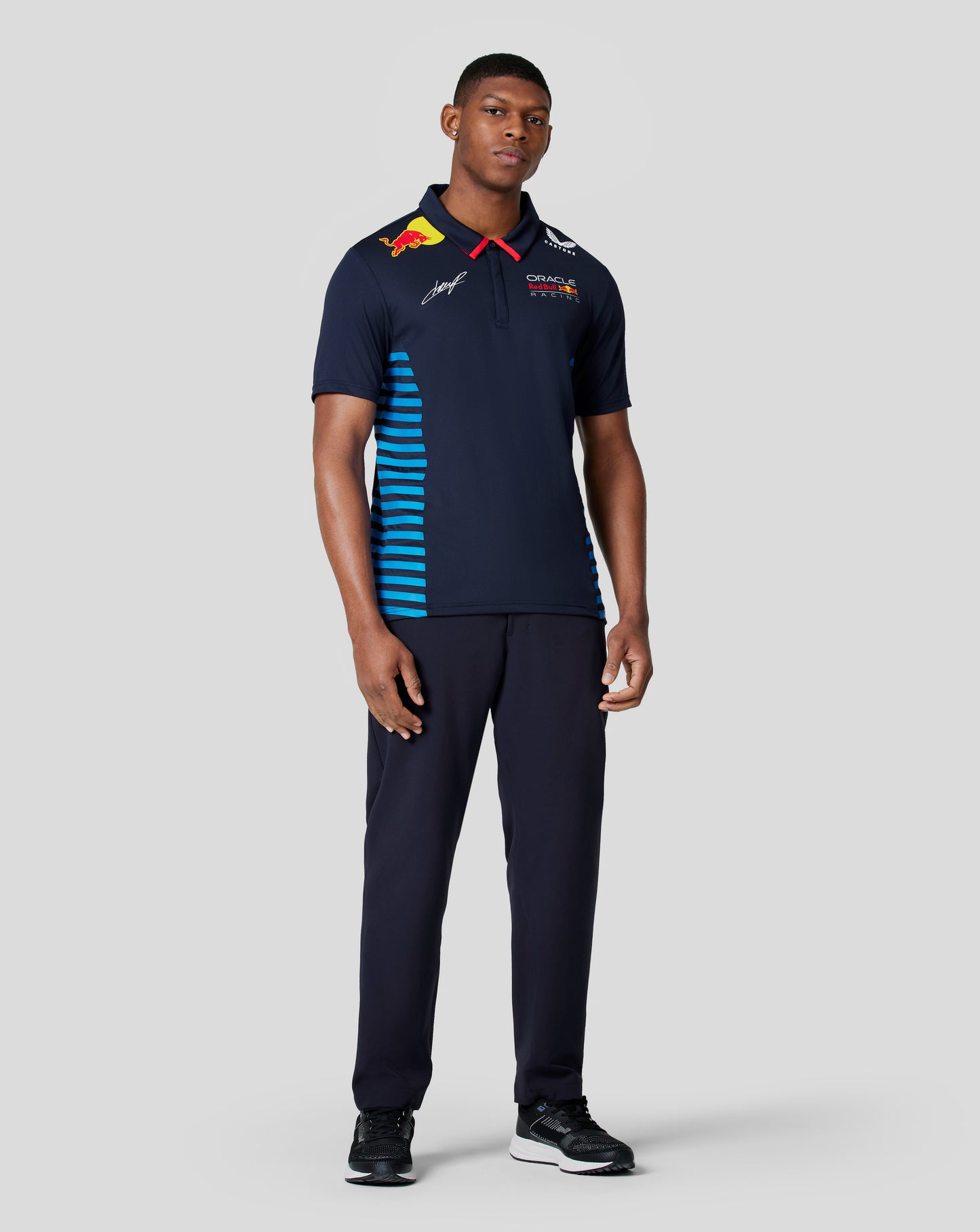Front view of Night Sky navy Teamline polo with Red Bull Racing logos and a yellow bull emblem on the shoulder plus red collar trim.