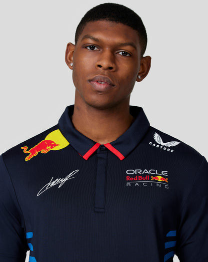Close up of Night Sky navy polo chest showing Oracle Red Bull Racing crest and Red Bull badge with a signature.