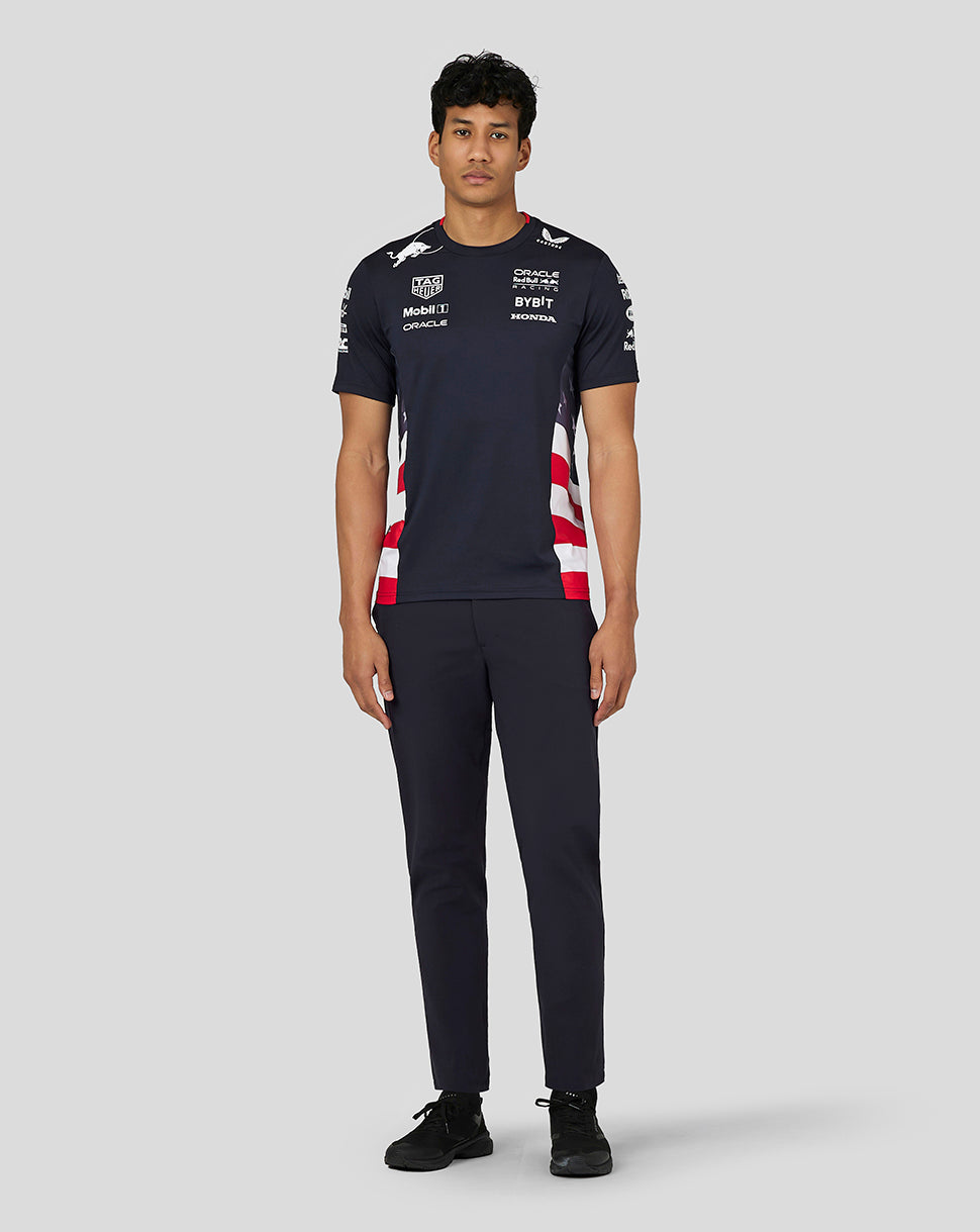 Front view of a male model wearing the navy Night Sky Race Team T Shirt with chest and sleeve branding and side panels