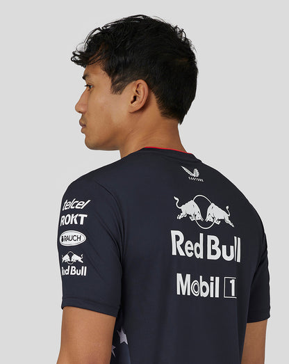 Profile view of a man wearing a night sky navy Oracle Red Bull Racing Teamline T shirt with large back Red Bull logo and sponsor graphics