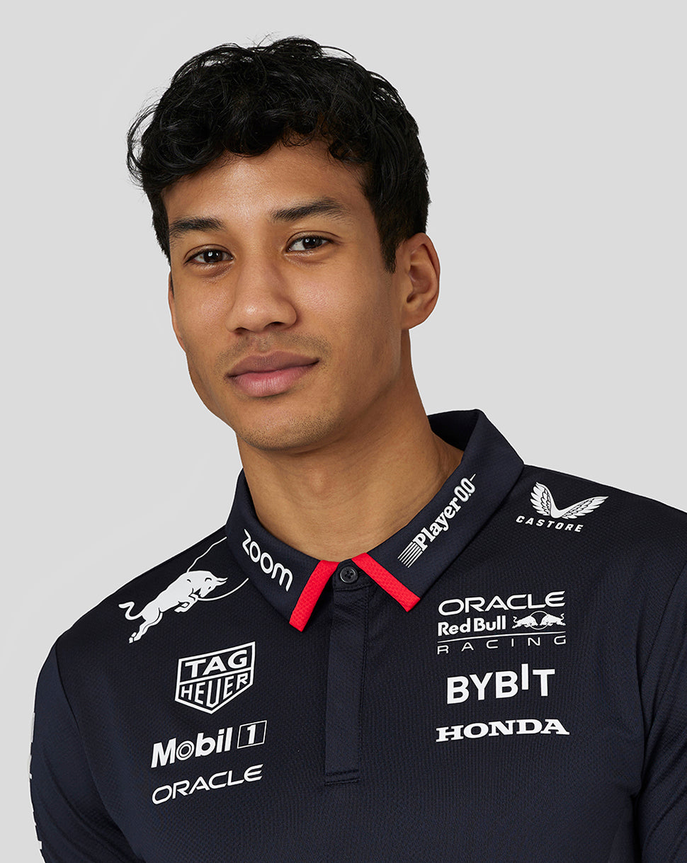 Male model wearing a night sky navy Oracle Red Bull Racing Teamline America polo with white sponsor logos across the chest.