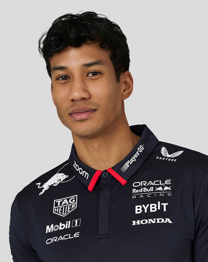 Male model wearing a night sky navy Oracle Red Bull Racing Teamline America polo with white sponsor logos across the chest.