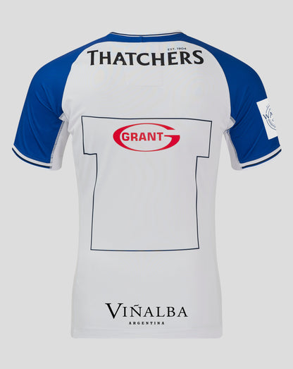 Back view of a white and blue rugby jersey with Thatchers across the upper back and a Grant sponsor patch on the lower back.