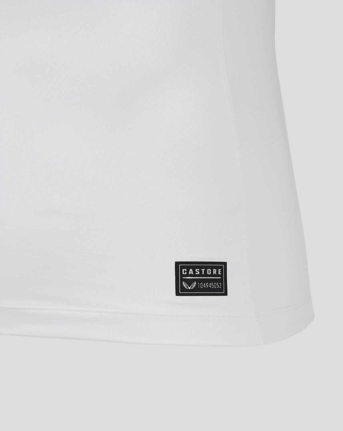 Close up of white Bath Rugby Away Pro Shirt hem with a Castore label stitched near the bottom.