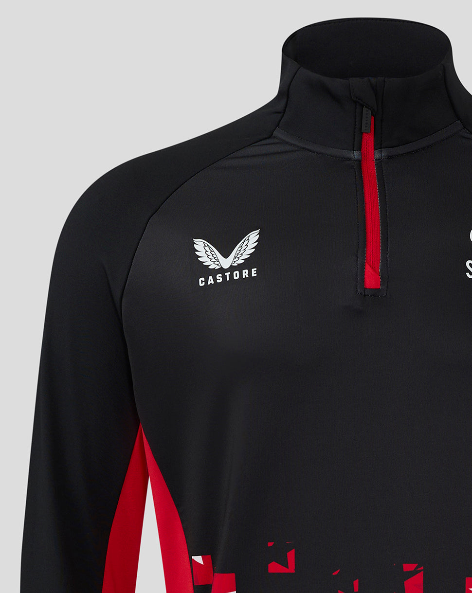 Close-up of black Saracens top featuring Castore logo on chest and a red front zipper.