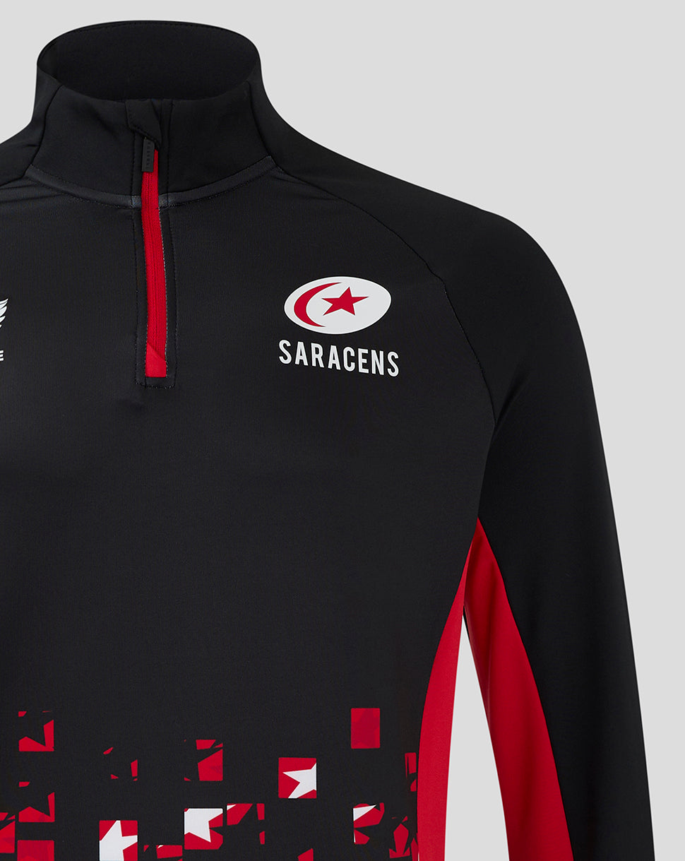 Close-up of black Saracens quarter-zip top with red zipper and team crest on the chest.