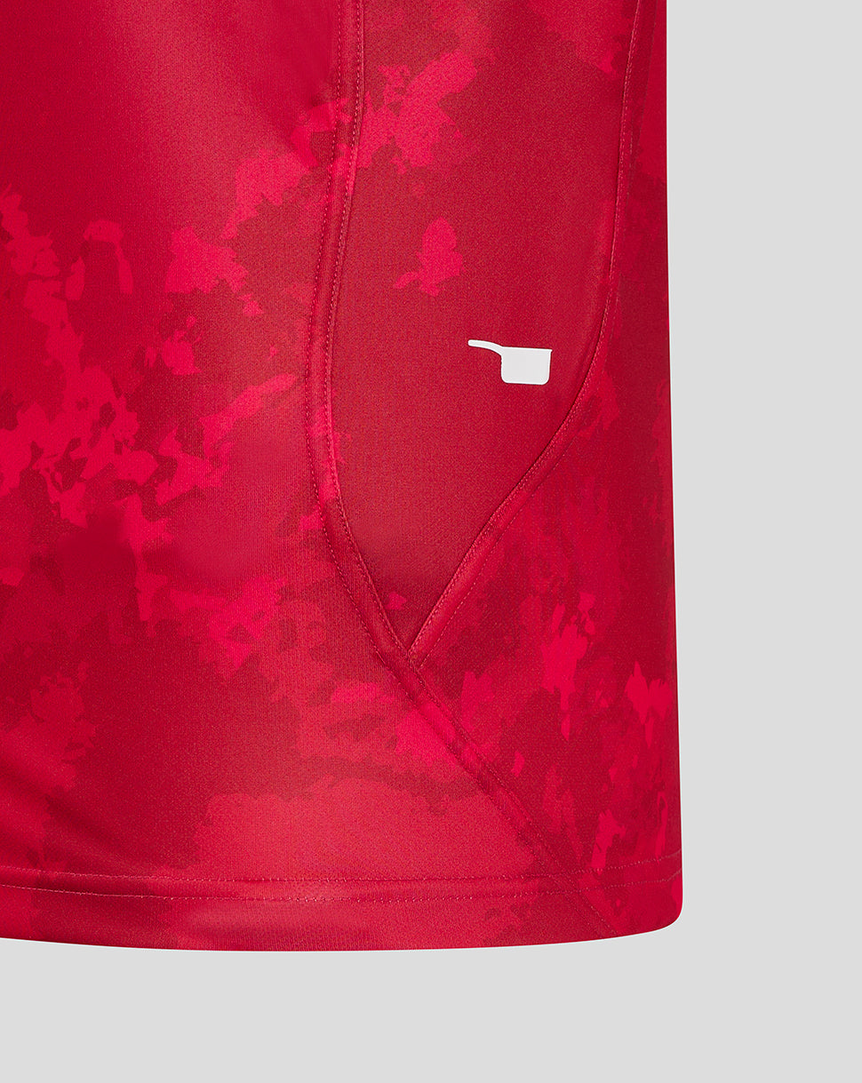 Close up of the Scarlets shirt sleeve hem with a small white emblem near the cuff.