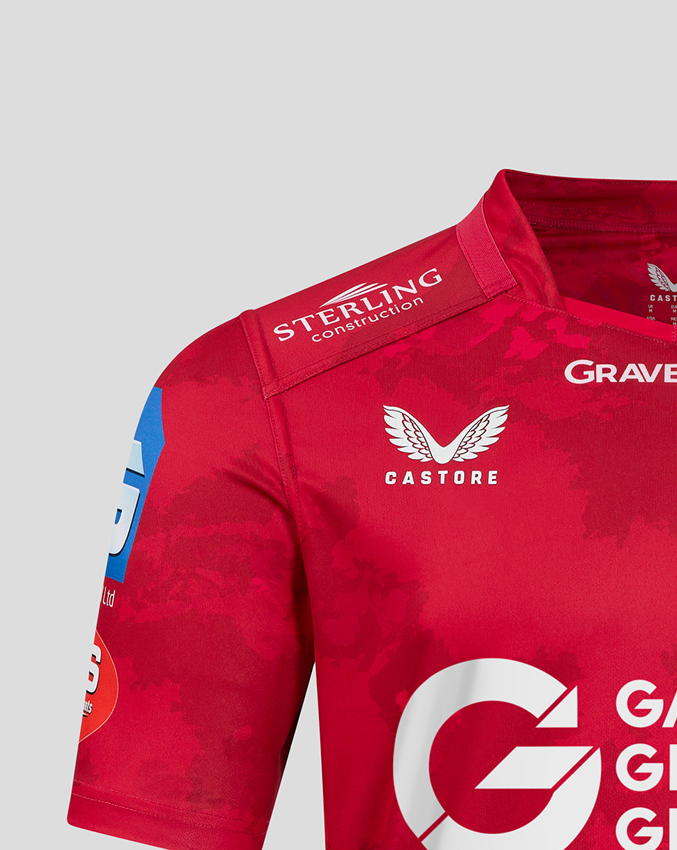Shoulder detail of red Scarlets home shirt with Castore branding and crest visible on upper chest
