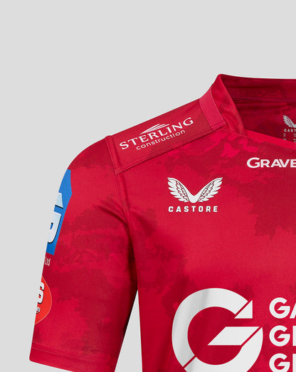 Shoulder detail of red Scarlets home shirt with Castore branding and crest visible on upper chest