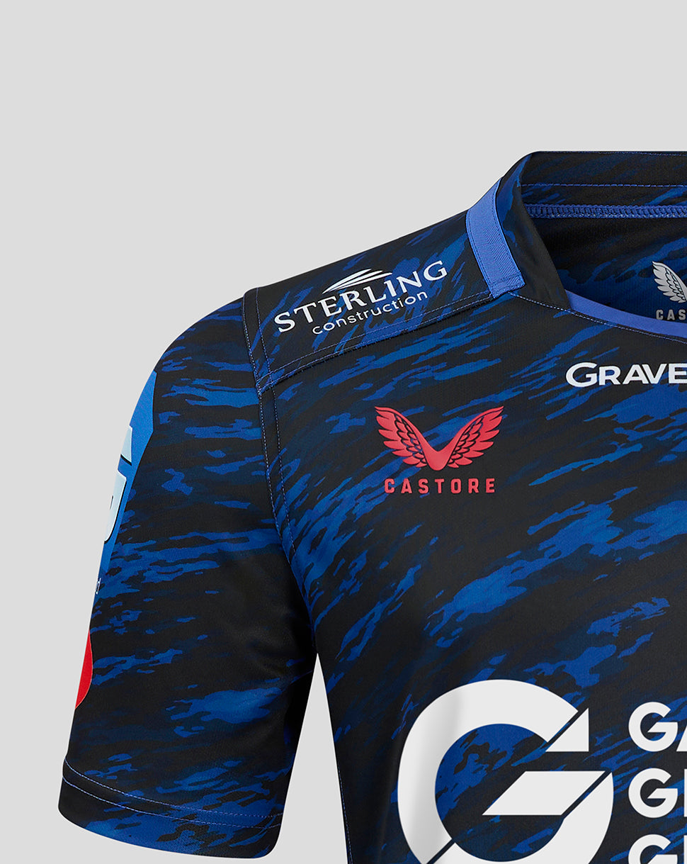 Shoulder close up of Scarlets away shirt showing Sterling Construction patch and Castore branding on blue camouflage fabric