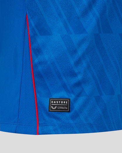 Close-up of blue Rangers home shirt fabric with red side piping and a Castore label near the hem