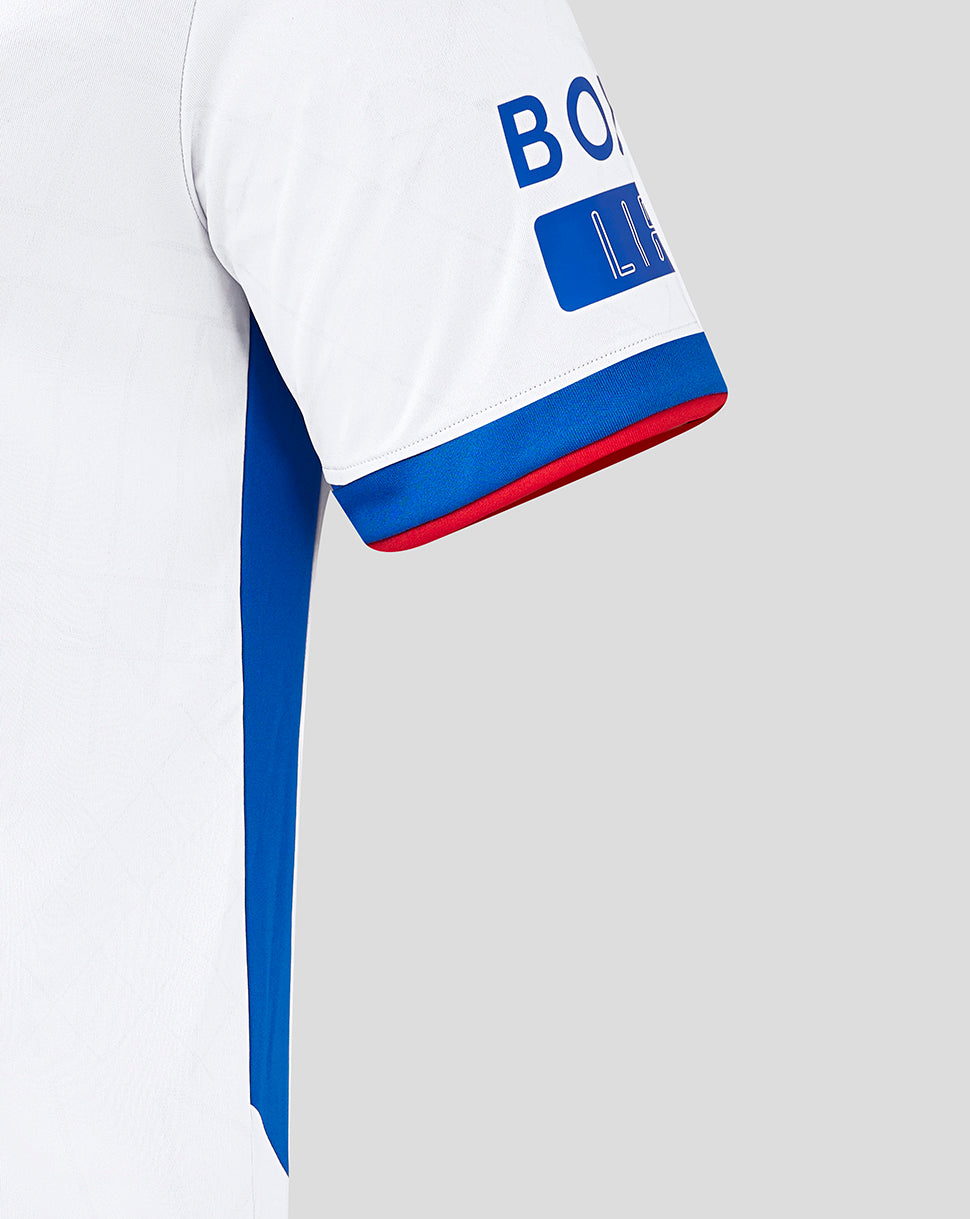 Close-up of sleeve edge showing white fabric with blue cuff trim and red piping.