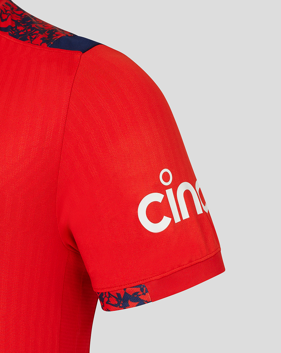 Close-up of Fiery Red England cricket shirt sleeve with navy patterned shoulder trim