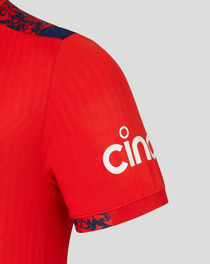 Close-up of Fiery Red England cricket shirt sleeve with navy patterned shoulder trim