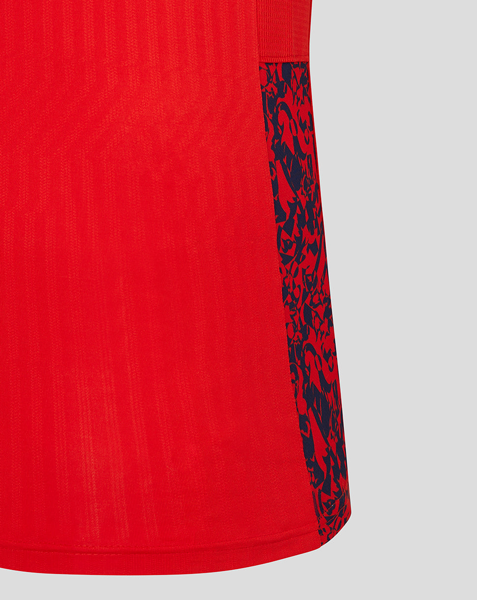 Side view of red England cricket shirt sleeve with navy patterned cuff panel