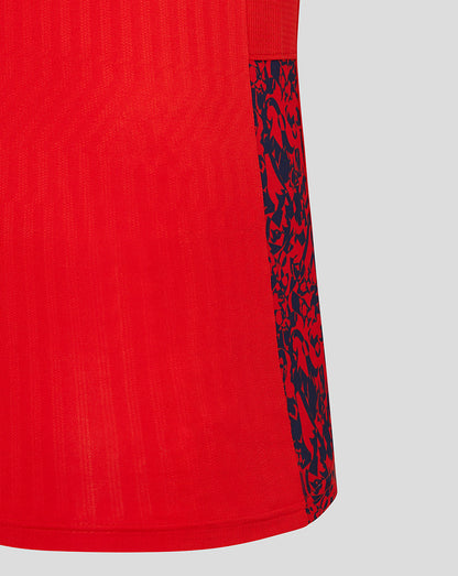 Side view of red England cricket shirt sleeve with navy patterned cuff panel