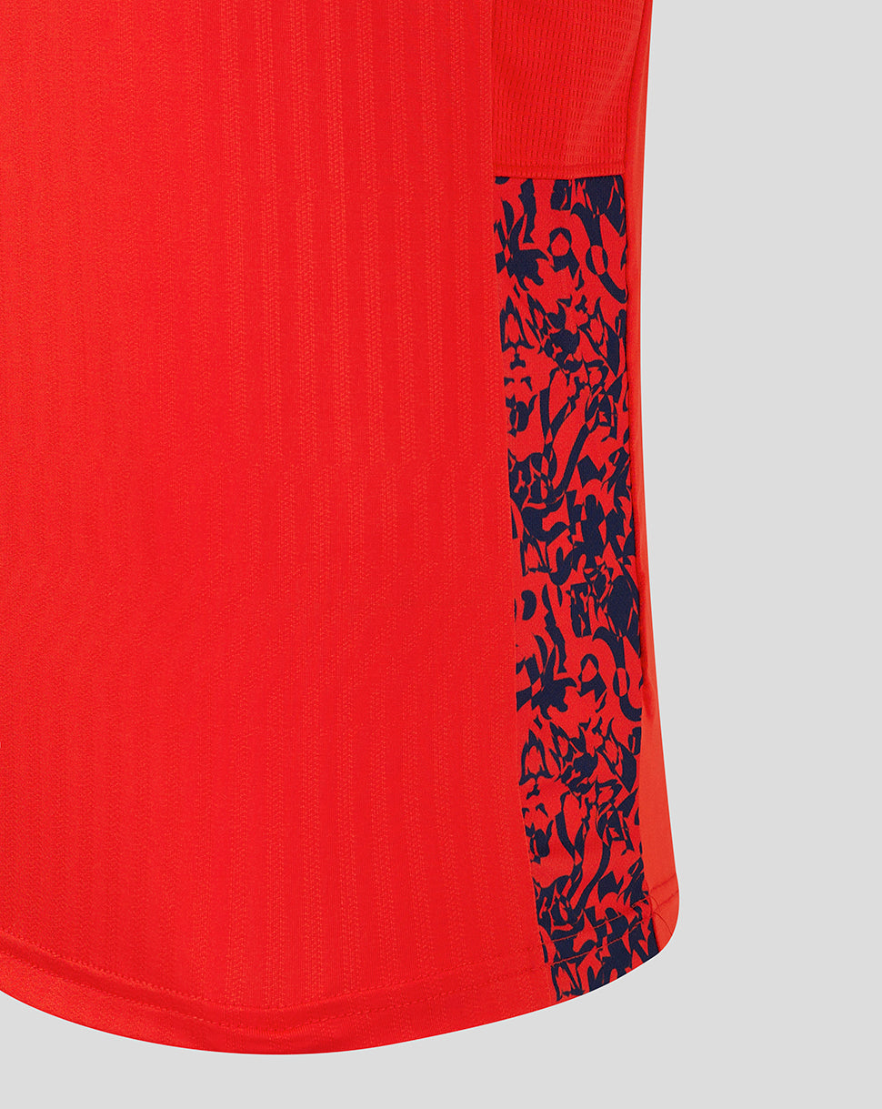 Close up of red England World Cup shirt showing a navy patterned side panel at the hem