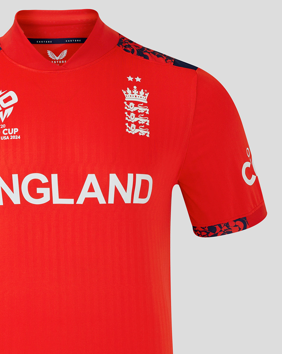 Shoulder and chest view of England World Cup T20 shirt with crest on left chest, ENGLAND across the front, and blue patterned shoulder trim.
