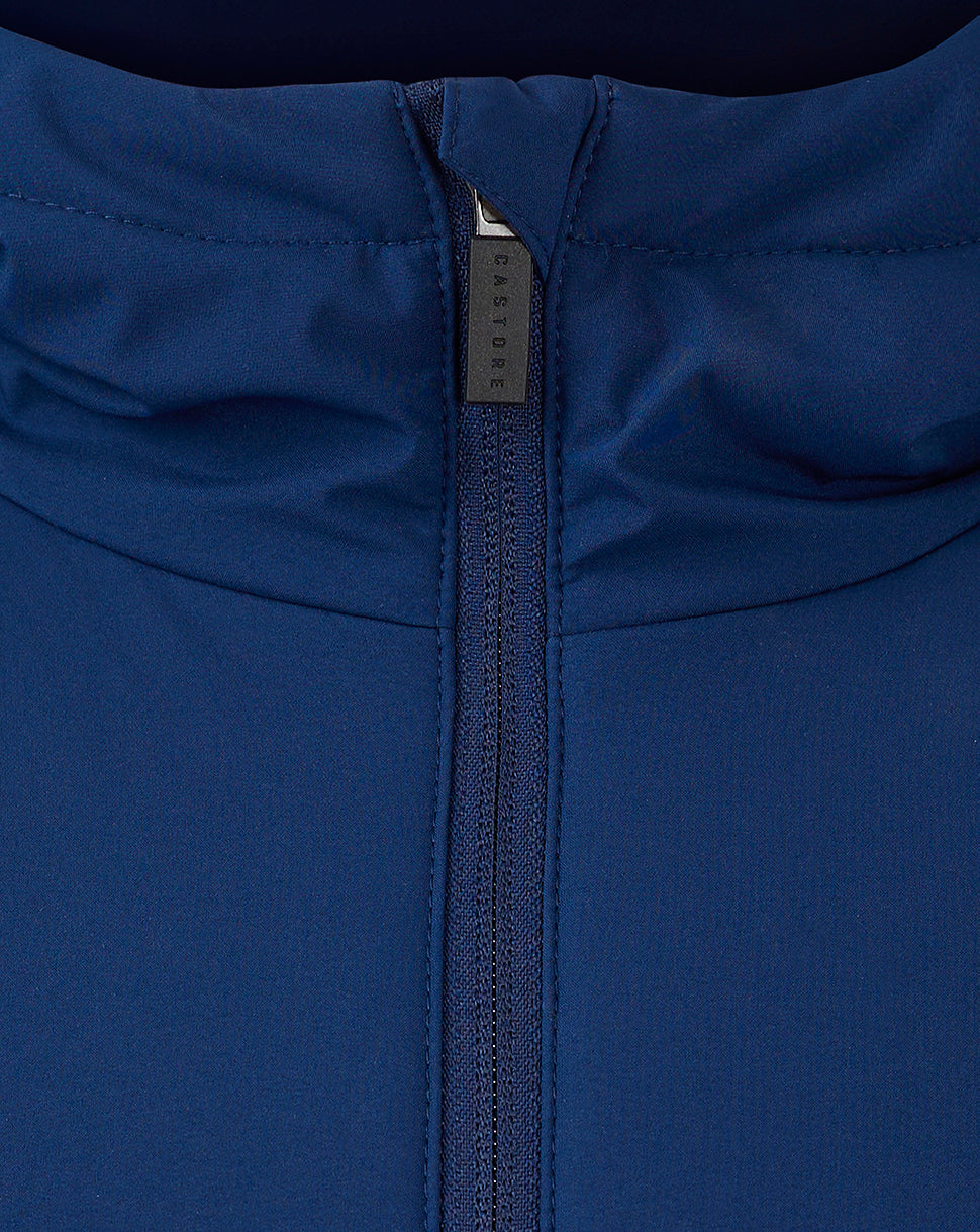 Close up of blue jacket zipper showing Castore branding on the pull