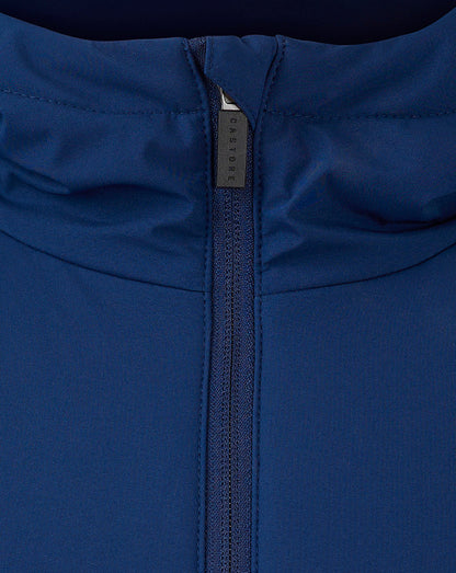 Close up of blue jacket zipper showing Castore branding on the pull
