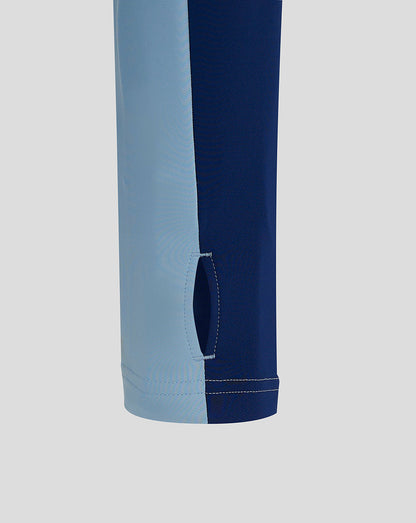 Close up of the hem area showing a curved side vent on a light blue and navy Rangers training top