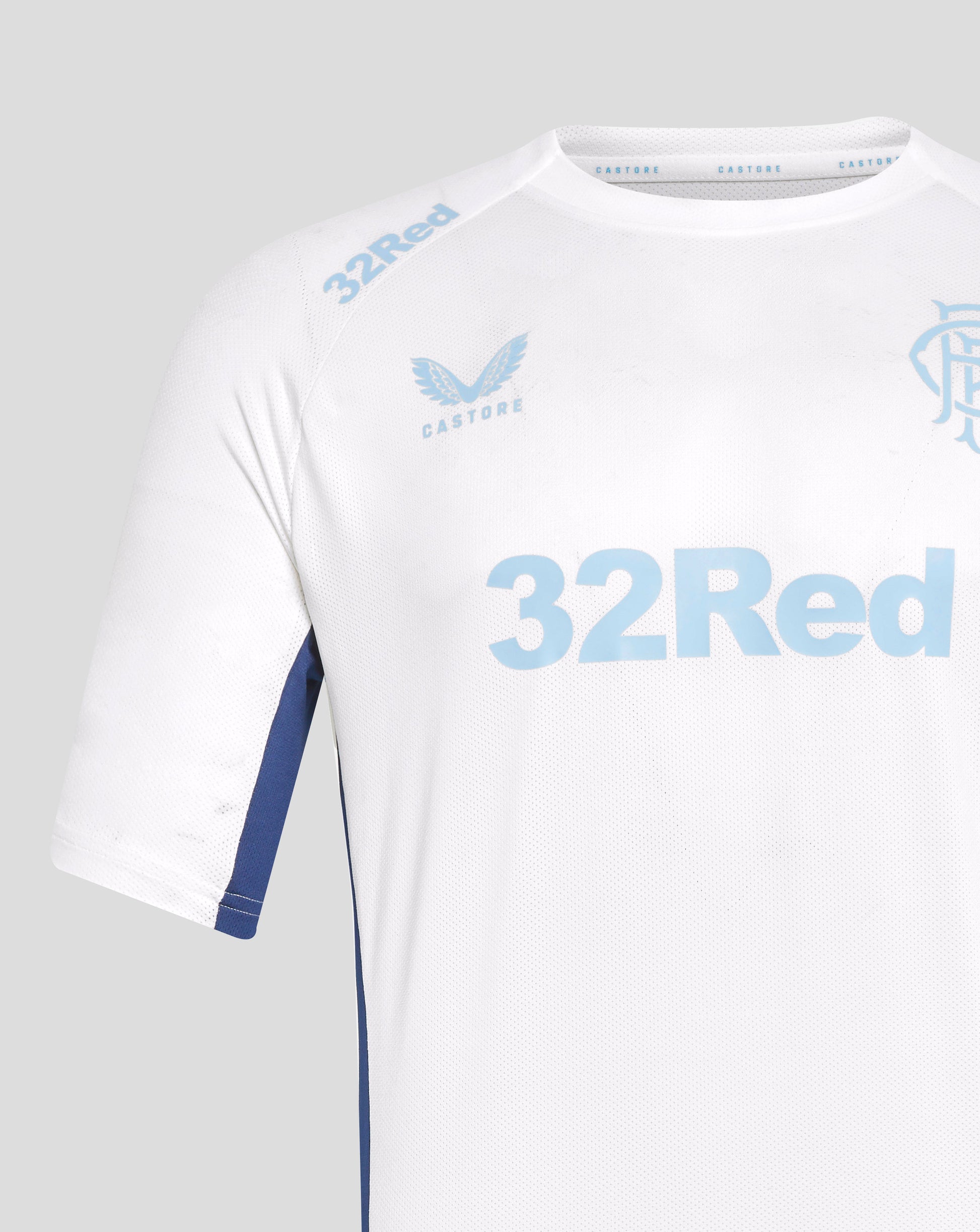 Close up of white Rangers training tee showing a light blue 32Red graphic on the shoulder and Castore branding at the neckline.
