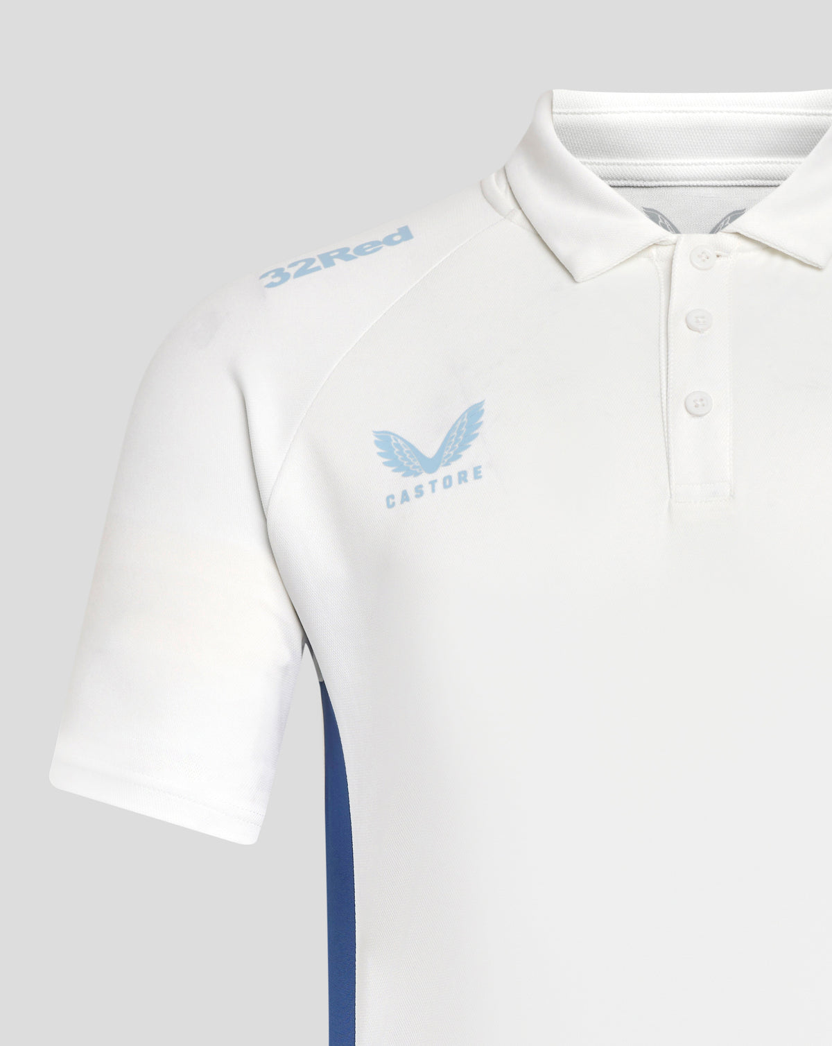 Close up of white Rangers polo with light blue 32Red shoulder logo and Castore wing crest on chest.