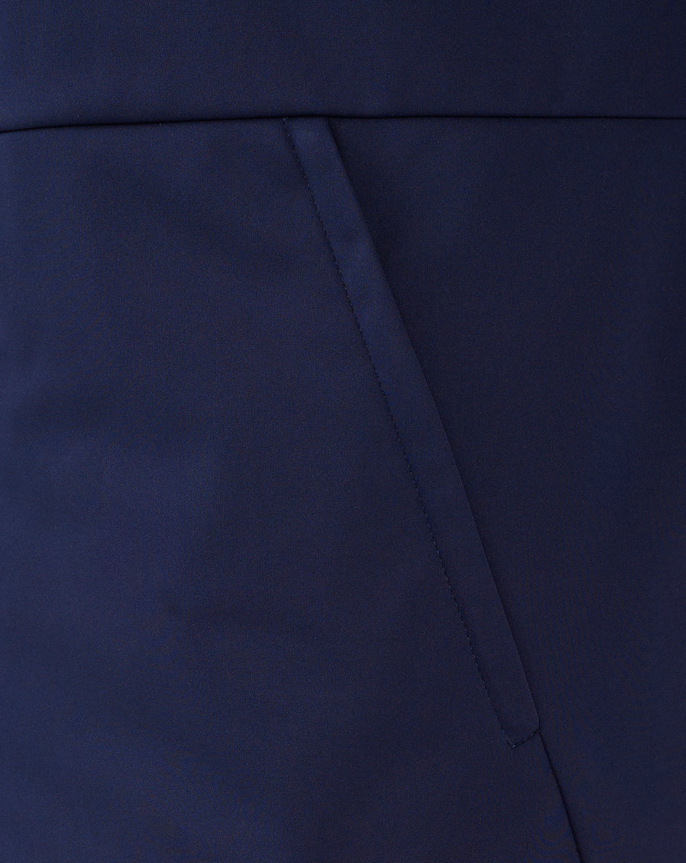 Close-up of navy softshell fabric and angled pocket seam on the Rangers travel jacket