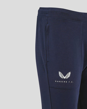 Close up of navy Rangers FC travel pant showing side pocket and white branding on the leg