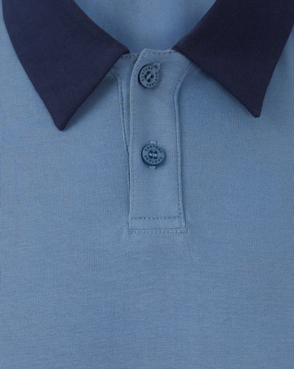 Close up of light blue Rangers travel polo showing a dark navy foldover collar and two button placket