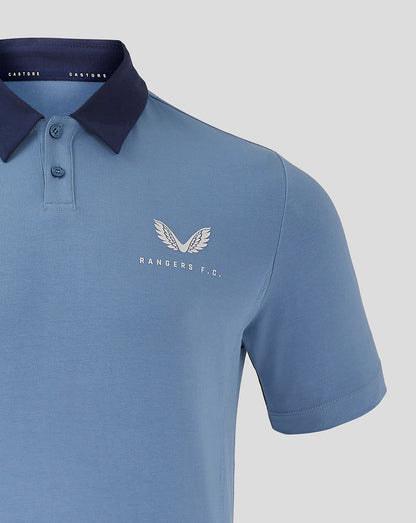 Close-up of light blue Rangers travel polo showing white wing crest and Rangers F.C. logo on left chest.