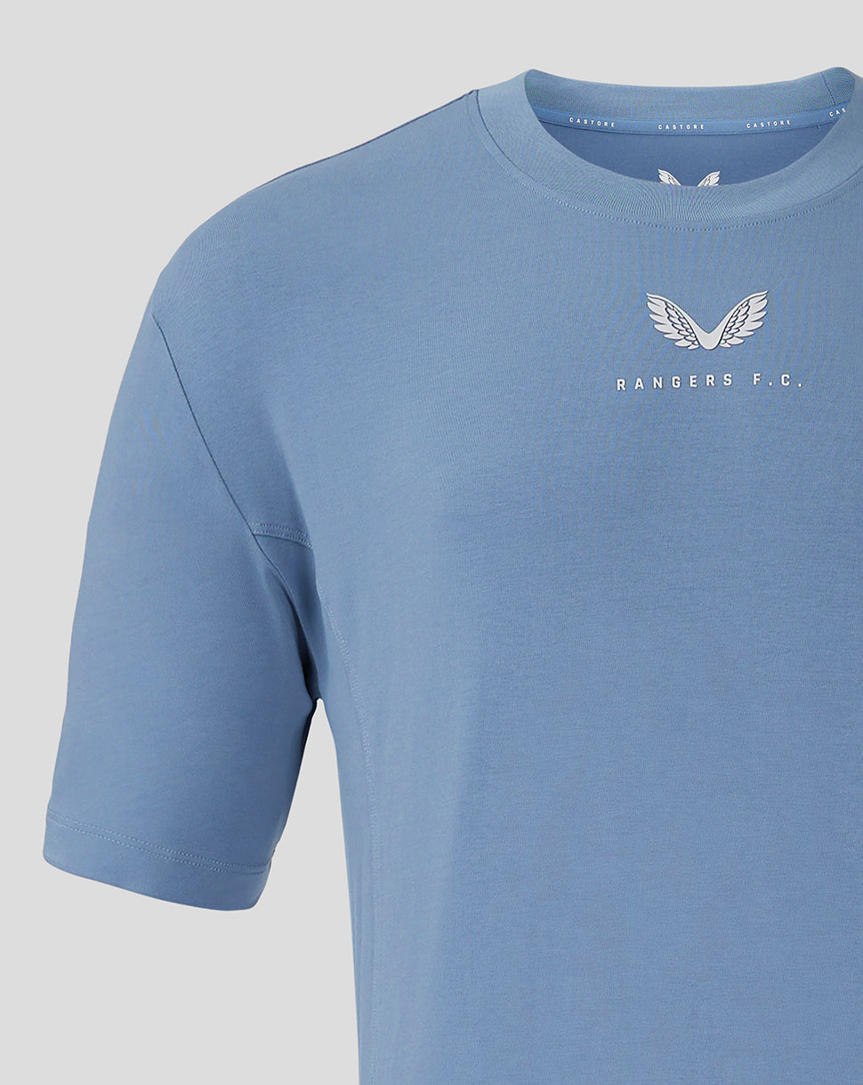 Close up of light blue Rangers FC travel shirt center chest with white winged crest and branding