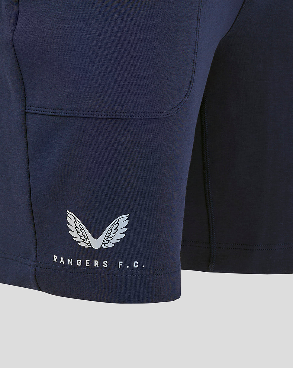 Close-up of navy shorts hem featuring Rangers FC crest and Castore branding at the bottom.