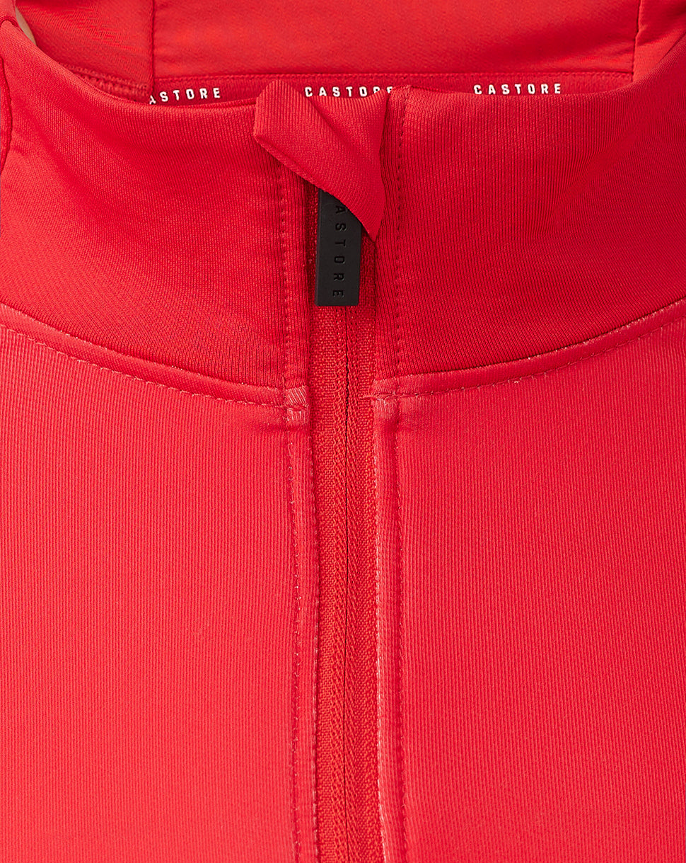 Close up of the red quarter zip neckline with visible zipper and Castore branding on the inside collar