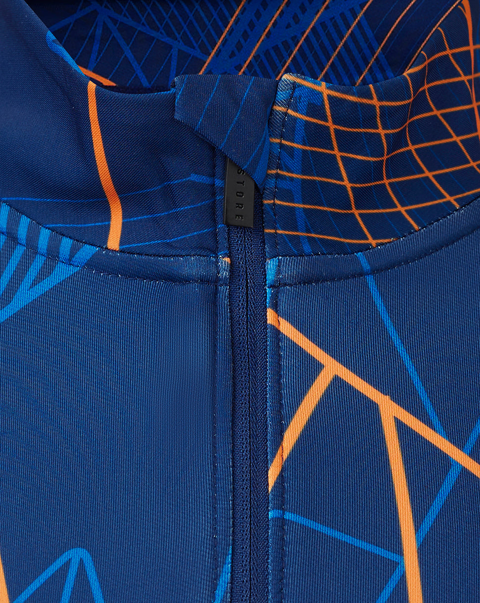 Close-up of back neck zipper on Rangers Matchday midlayer showing funnel collar and bold geometric print